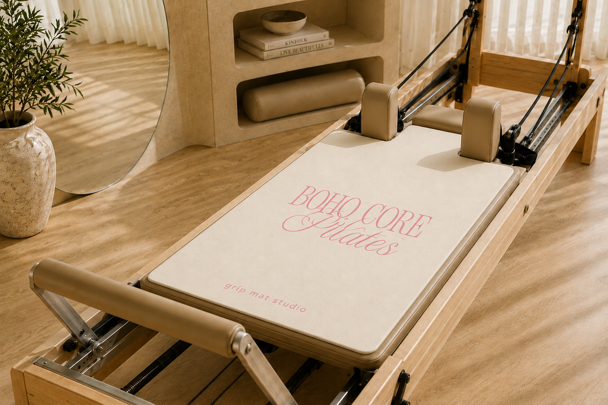 Pink Pilates reformer grip mat on a beige reformer in a luxury Pilates studio