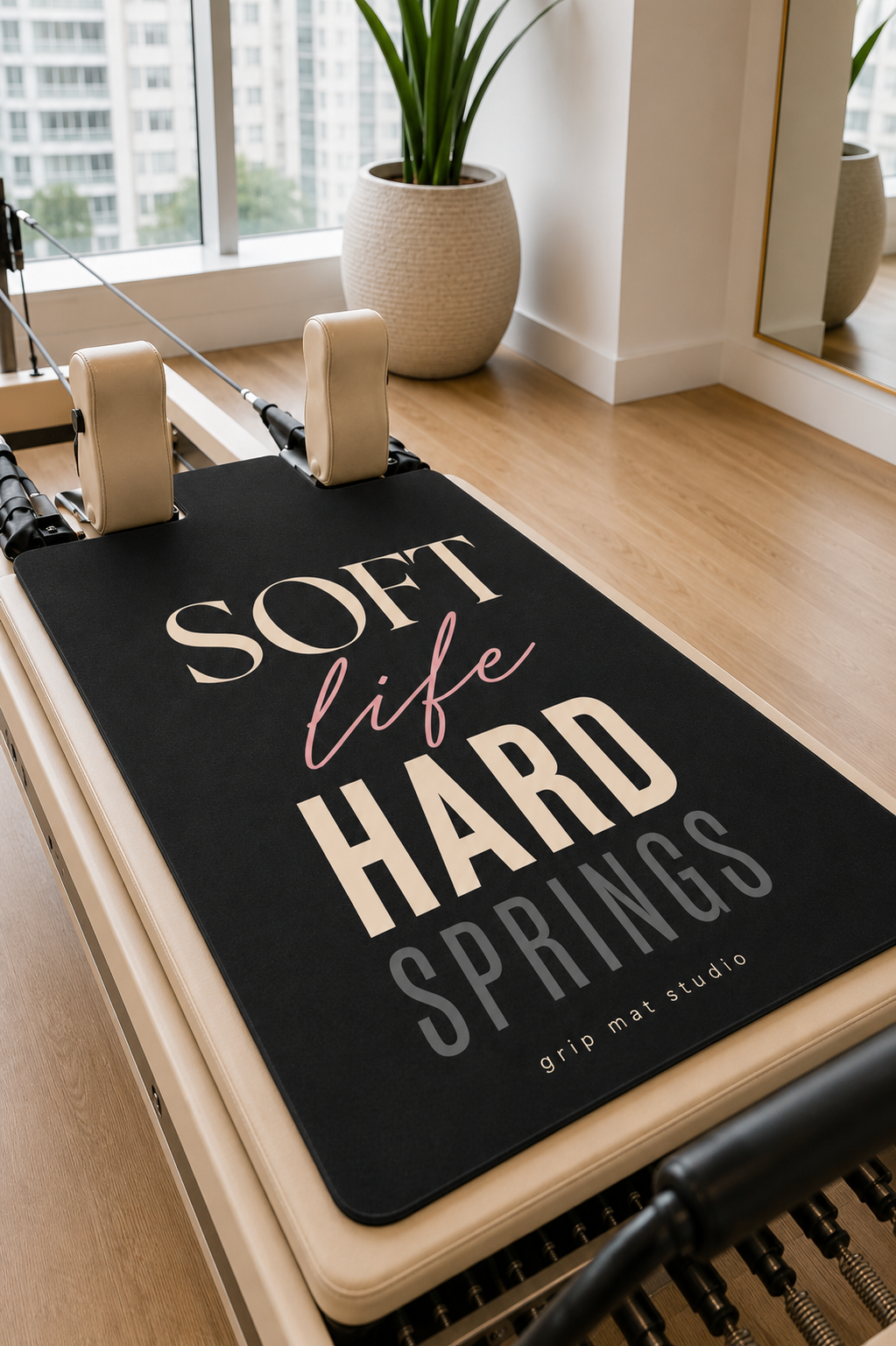 Soft Life Hard Springs Pilates reformer grip mat on a beige Merrithew-style reformer