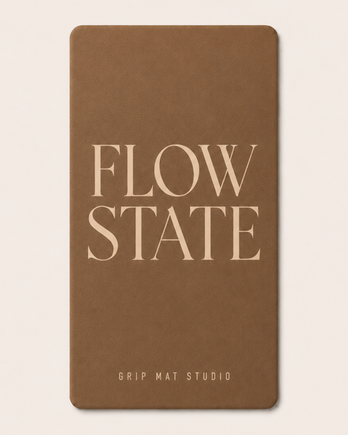 Brown Flow State yoga mat with beige serif lettering and Grip Mat Studio logo on a cream background