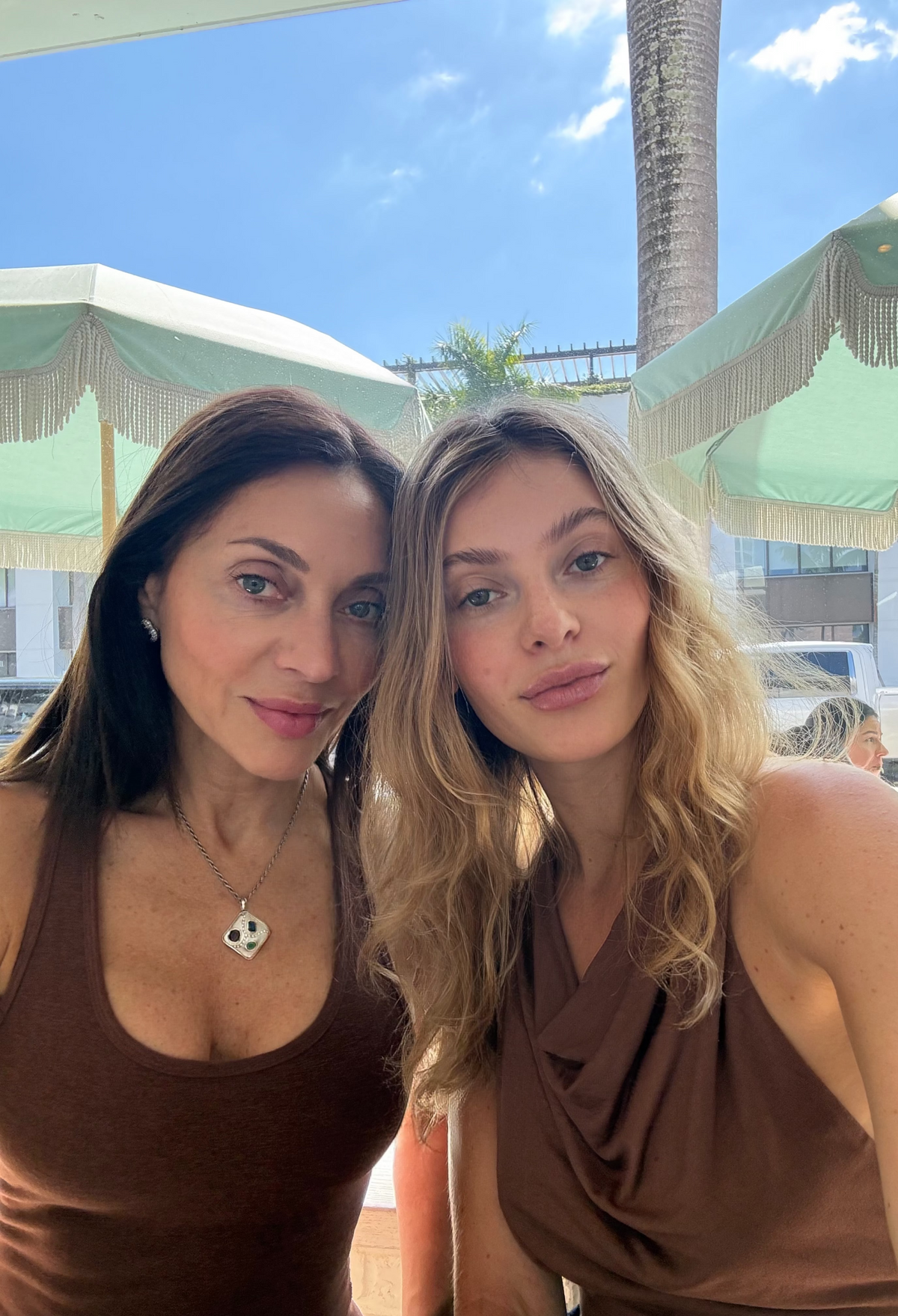 Mother-daughter founders of Grip Mat Studio smiling together outdoors