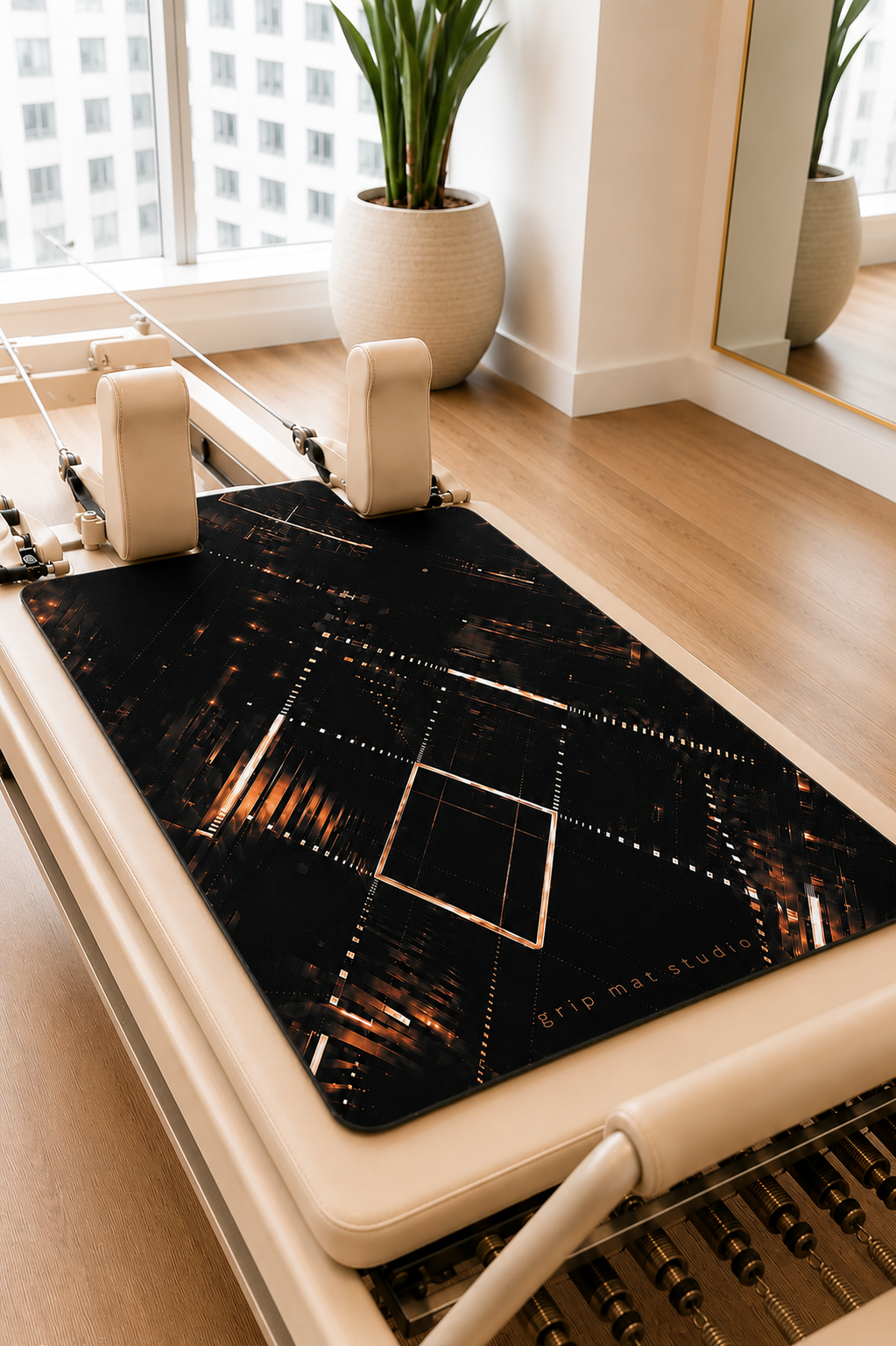 After hours black with lights Pilates reformer grip mat displayed on a beige commercial studio reformer.